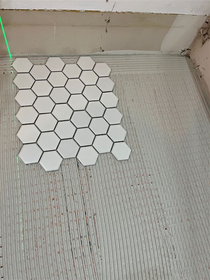 First sheet of white hex mosaic set against a laser line